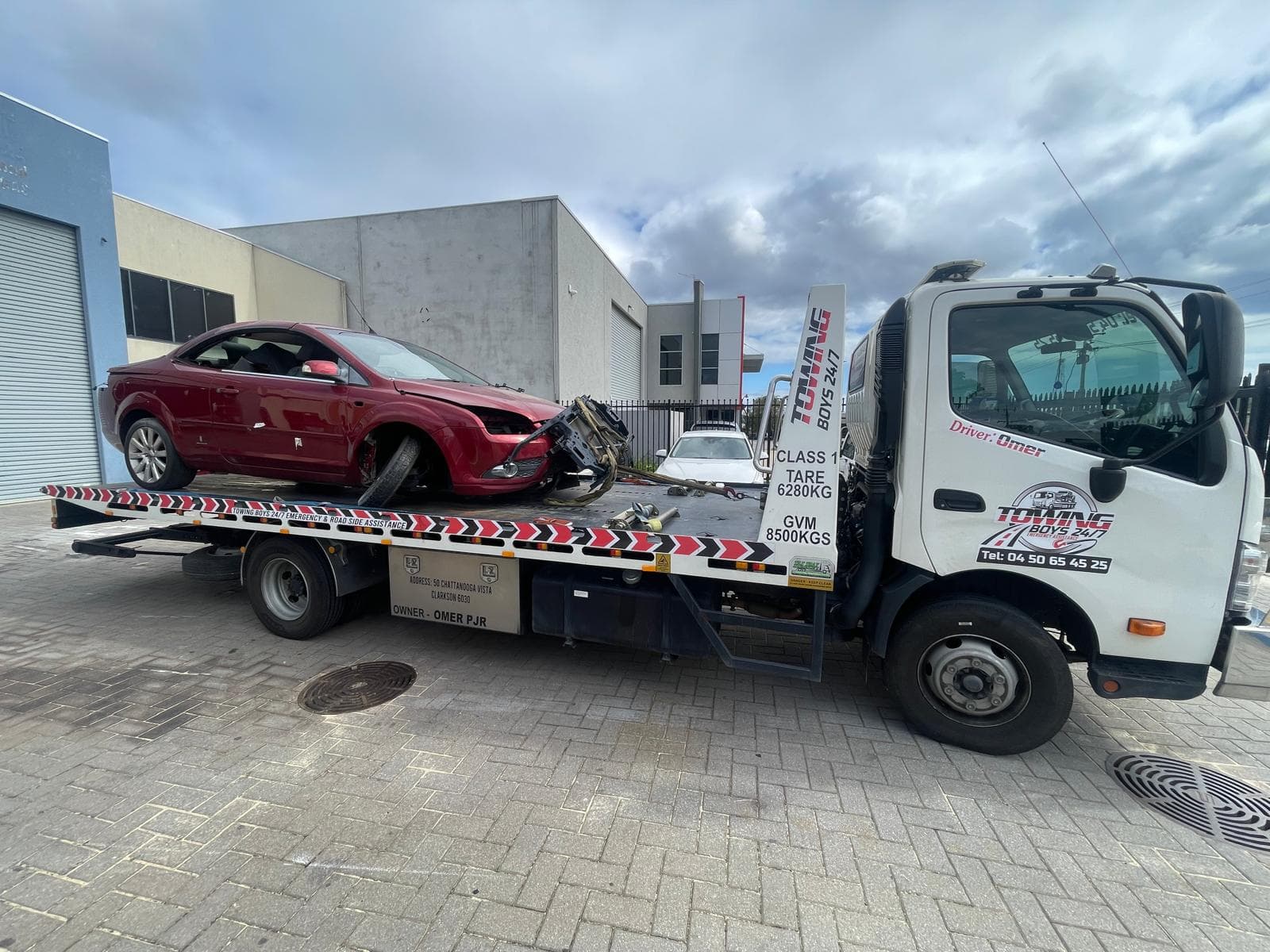 Towing Boys 24/7 recovering a crash-damaged coupe in a Perth industrial area